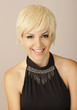 Beautiful young woman with short blond hair looking at camera