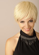 Beautiful young woman with short blond hair looking at camera