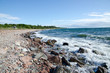 Coast with rocks and a small house