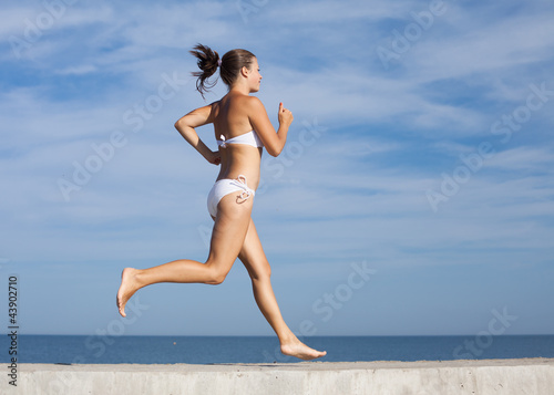 Photo: Sportswoman running outdoors Sportswoman running outdoors