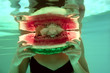 Foto: Biting ripe watermelon Biting ripe watermelon