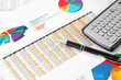 Calculator  and Pen on the Investment Charts