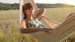 Video: Pretty young girl swinging on hammock at sunset Pretty young girl swinging on hammock at sunset