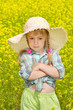 The sad little girl among a blossoming field
