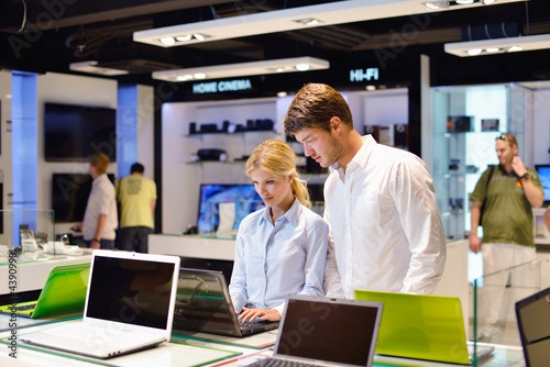Photo: Young couple in consumer electronics store Young couple in consumer electronics store