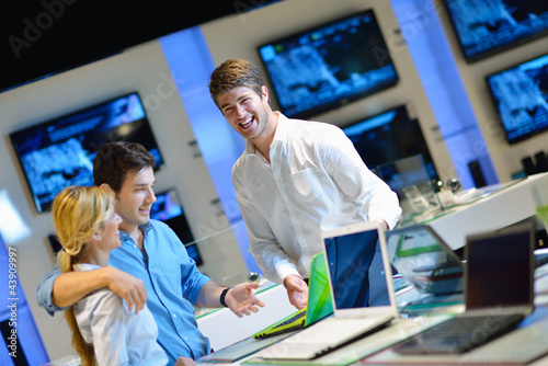 Photo: Young couple in consumer electronics store Young couple in consumer electronics store