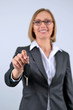 Young and beautiful business woman holding her new car key