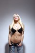 partly nude young woman with bra and denim jeans