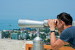 Foto: man looking through binoculars man looking through binoculars