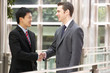 Photo: Two Businessmen Shaking Hands Outside Office Two Businessmen Shaking Hands Outside Office