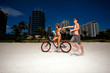 Young couple on Miami Beach Riding bikes and having fun