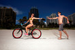 Young couple on Miami Beach Riding bikes and having fun