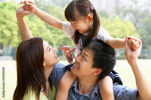 Photo: Chinese Family Giving Daughter Ride On Shoulders In Park Chinese Family Giving Daughter Ride On Shoulders In Park