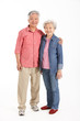 Full Length Studio Shot Of Chinese Senior Couple