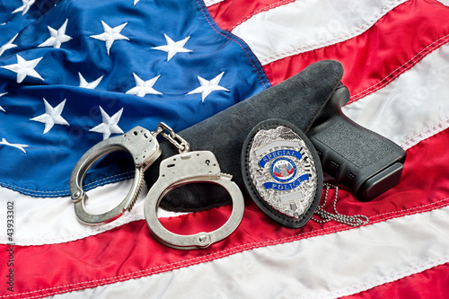 Photo: Police badge and gun Police badge and gun