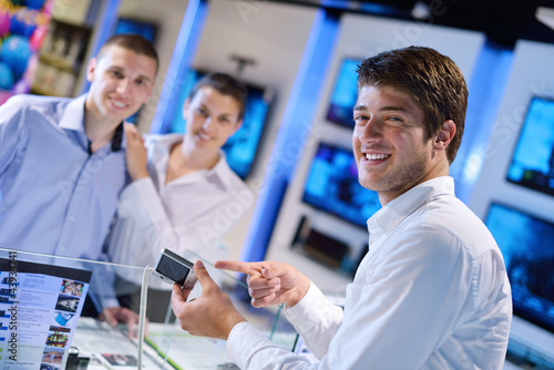 Photo: Young couple in consumer electronics store Young couple in consumer electronics store
