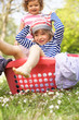 Young Boy Sitting In Laundry Basket
