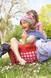 Young Boy Sitting In Laundry Basket