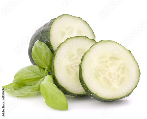 Photo: Sliced cucumber vegetable and basil leaves still life Sliced cucumber vegetable and basil leaves still life