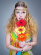 Foto: The beautiful young woman with long hair holds colorful flowers The beautiful young woman with long hair holds colorful flowers