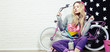 Foto: young woman with pink bike at home young woman with pink bike at home