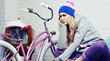 Foto: young woman with pink bike at home young woman with pink bike at home