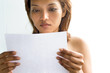 Young woman reading a letter..