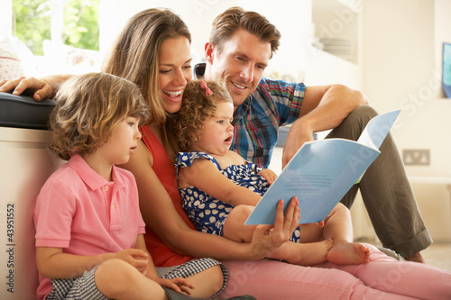 Photo: Parents Sitting With Children Reading Story Indoors Parents Sitting With Children Reading Story Indoors