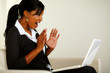 Surprised young woman reading great news on laptop