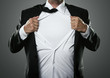 Young businessman acting like a super hero