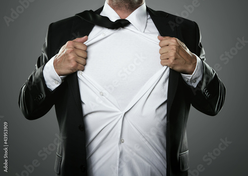 Photo: Young businessman acting like a super hero Young businessman acting like a super hero