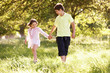 Photo: Boy And Girl Walking Through Summer Field Together Boy And Girl Walking Through Summer Field Together