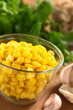 Sweetcorn grains in glass bowl with garlic and watercress