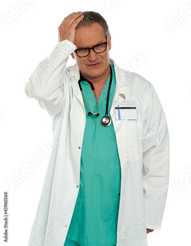 Photo: Senior physician having headache Senior physician having headache