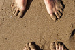 Foto: Couple's feet in sand Couple's feet in sand