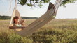 Vídeo: Pretty young girl swinging on hammock at sunset Pretty young girl swinging on hammock at sunset