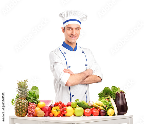 Photo: Male chef with fruits and vegetables on table Male chef with fruits and vegetables on table