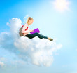 Photo: School Girl or Student Sitting on a Cloud and Reading a book School Girl or Student Sitting on a Cloud and Reading a book