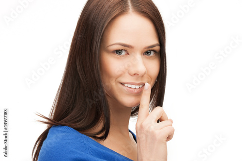 Photo: happy woman with finger on lips happy woman with finger on lips