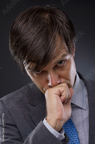 Photo: portrait of handsome young business man thinking portrait of handsome young business man thinking