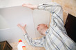 Man glues ceiling tile