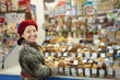 Mature woman chooses sweets