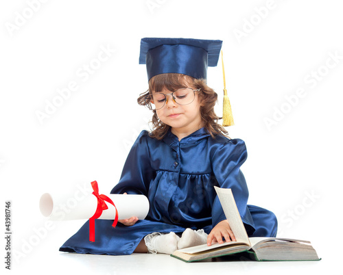 Foto : Little girl kid in academician clothes with book Little girl kid in academician clothes with book
