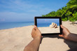 Foto: hands holding tablet pc on beach hands holding tablet pc on beach