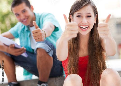 Photo: Teenage couple with thumbs up Teenage couple with thumbs up
