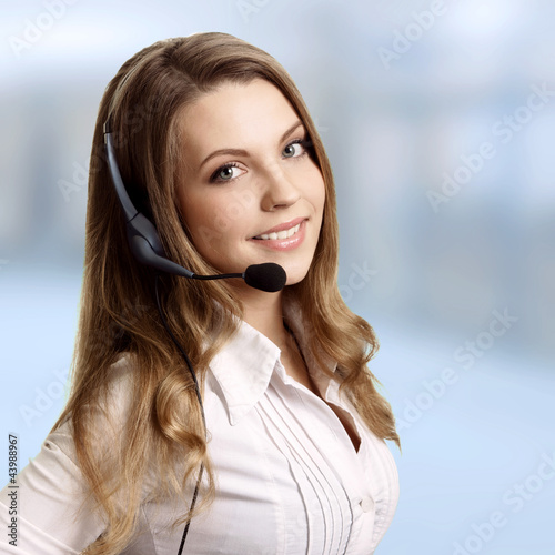 Photo: Beautiful young laughing cheerful woman and headphones with micr Beautiful young laughing cheerful woman and headphones with micr