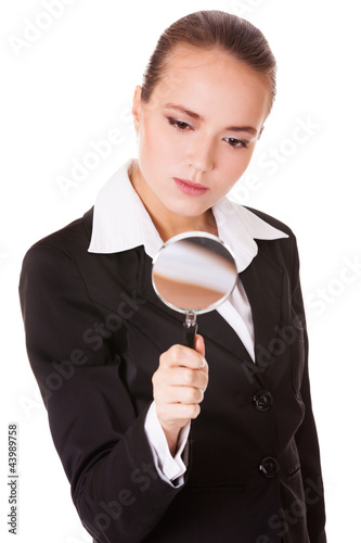 Foto: Attentive business woman with loupe Attentive business woman with loupe
