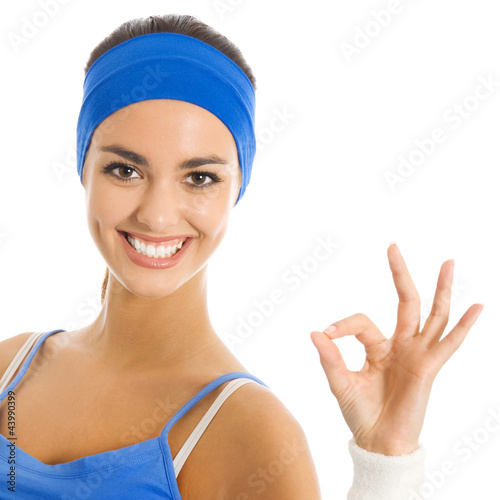 Photo: Portrait of smiling woman with OK sign, over white Portrait of smiling woman with OK sign, over white