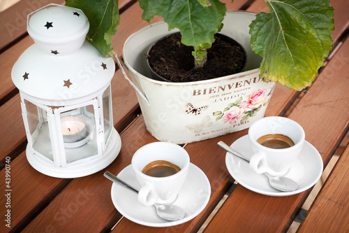 Photo: Two cups of espresso coffee cafeteria garden table Two cups of espresso coffee cafeteria garden table