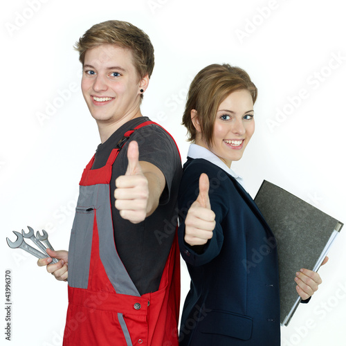 Photo: Apprentices for car mechanic and office having thumbs up Apprentices for car mechanic and office having thumbs up
